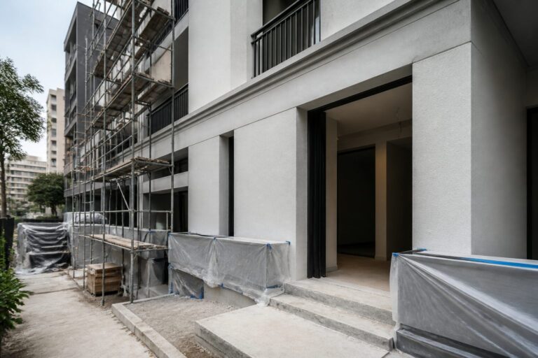 Edifício em fase de acabamento, com andaimes e proteção na fachada